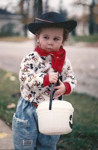 My second daughter Aynsley, enjoying daytime trick or treating.  She's wearing a black hat...because even at that age being the bad guy is more fun.  